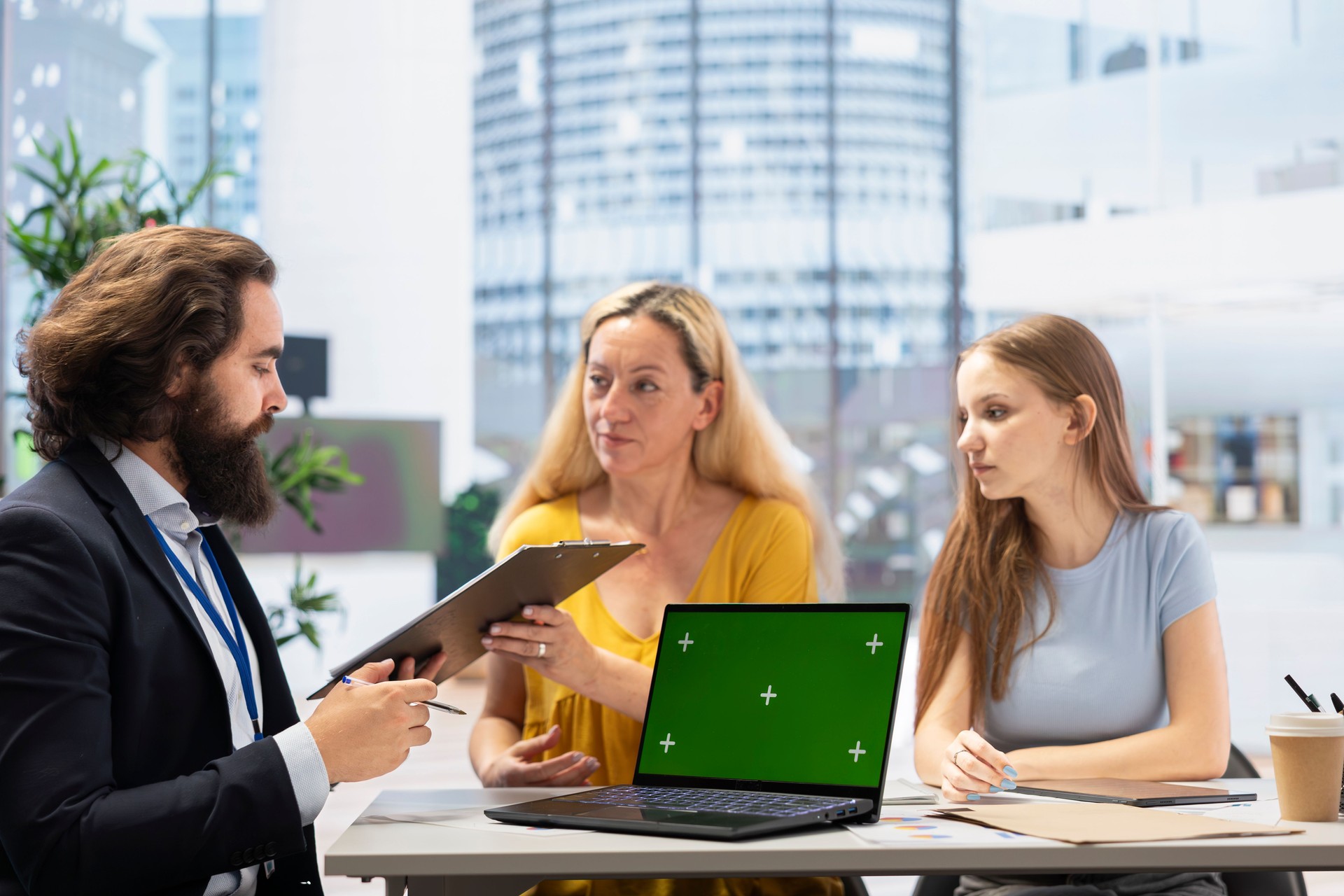 Family receiving financial plan from financial advisor using green screen laptop